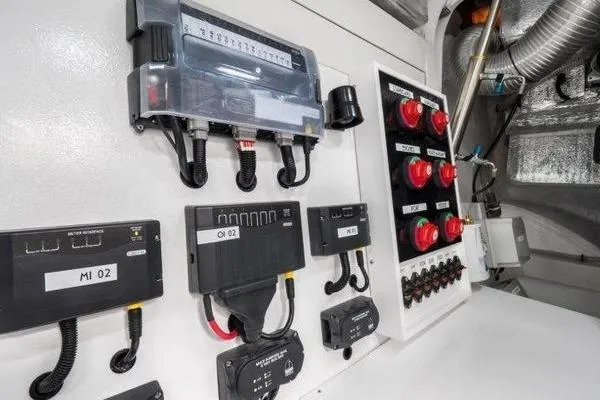 Slide: The Image of Electrical control panel inside 2021 OKEAN FB Motor Yacht, featuring switches and wiring. - 28