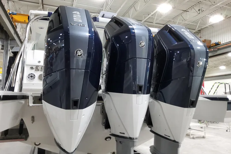 Slide: The Image of 2026 Formula 380 Super Sport Crossover OB with triple outboard engines in a showroom. - 10