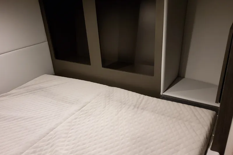 Slide: The Image of Interior cabin of 2026 Formula 380 Super Sport Crossover OB, featuring a cozy bed. - 100