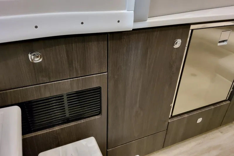 Slide: The Image of 2026 Formula 380 Super Sport Crossover OB interior cabinetry with sleek wood finish and stainless steel accents. - 103