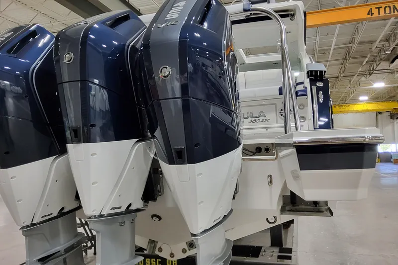 Slide: The Image of 2026 Formula 380 Super Sport Crossover OB with powerful outboard engines in a showroom. - 11