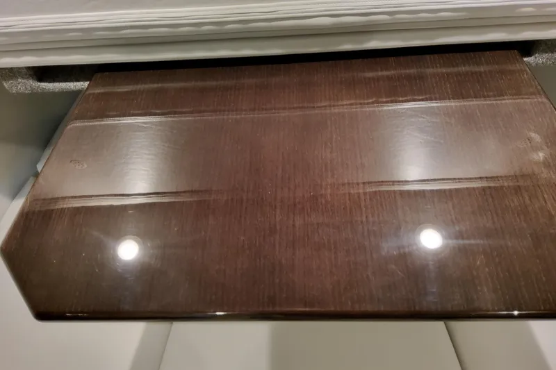 Slide: The Image of Polished wooden surface on 2026 Formula 380 Super Sport Crossover OB boat interior. - 115