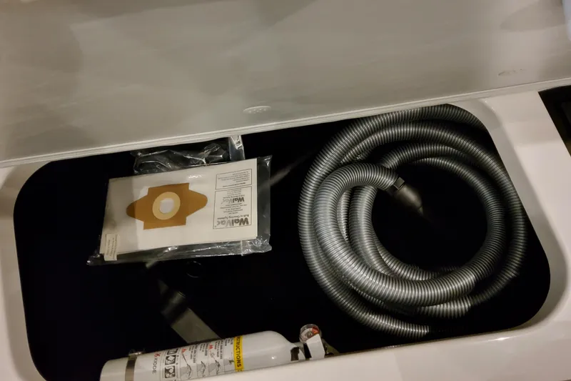 Slide: The Image of Storage compartment in 2026 Formula 380 Super Sport Crossover OB with hose and fire extinguisher. - 117