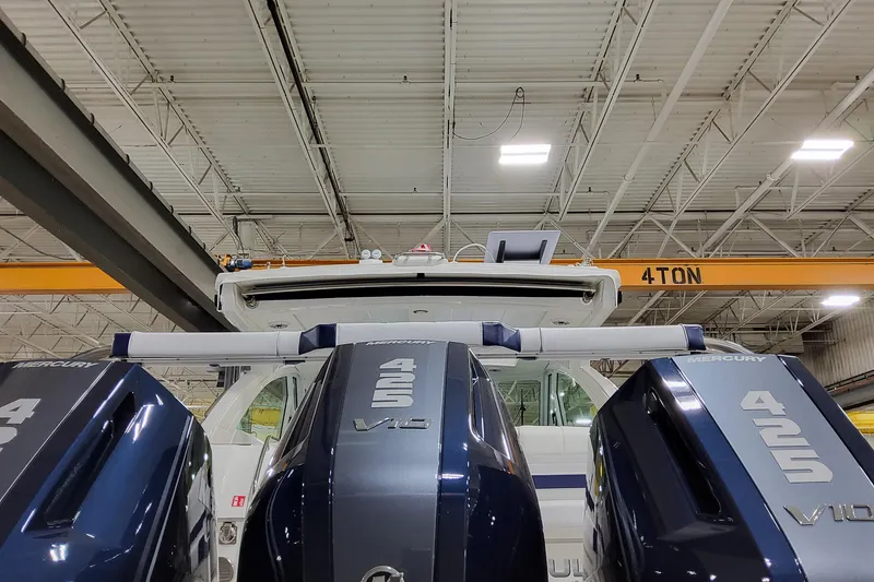 Slide: The Image of 2026 Formula 380 Super Sport Crossover OB with Mercury 425 V10 engines in a warehouse. - 13