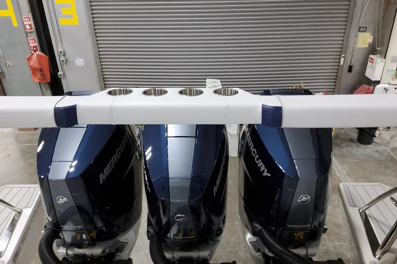 Slide: The Image of 2026 Formula 380 Super Sport Crossover OB with triple Mercury outboard engines in a garage setting. - 17