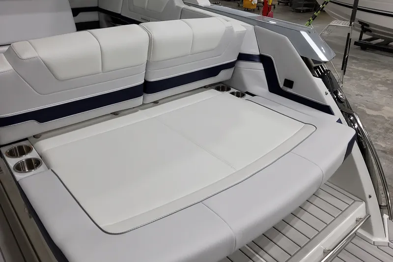 Slide: The Image of 2026 Formula 380 Super Sport Crossover OB boat interior with white seating and cup holders. - 19