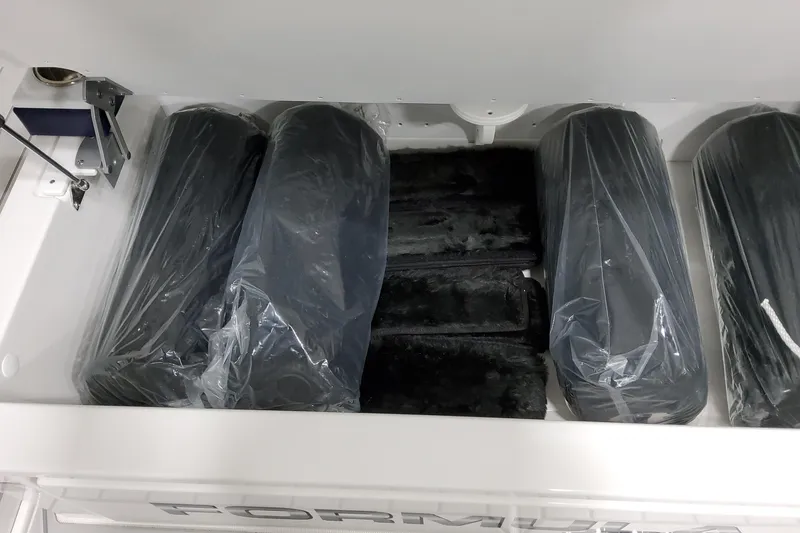 Slide: The Image of Storage compartment with packaged items in a 2026 Formula 380 Super Sport Crossover OB boat. - 20