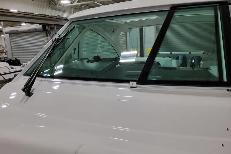 Slide: The Image of 2026 Formula 380 Super Sport Crossover OB boat windshield in a showroom setting. - 27