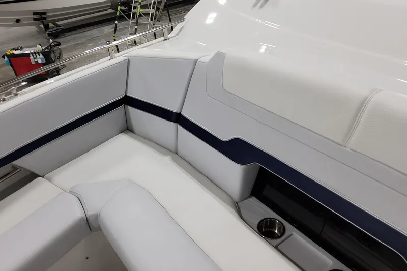 Slide: The Image of Luxurious seating on 2026 Formula 380 Super Sport Crossover OB boat, featuring sleek design and cup holder. - 29