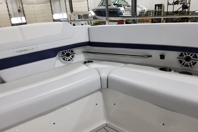 Slide: The Image of Interior of 2026 Formula 380 Super Sport Crossover OB boat with white seating and speakers. - 31