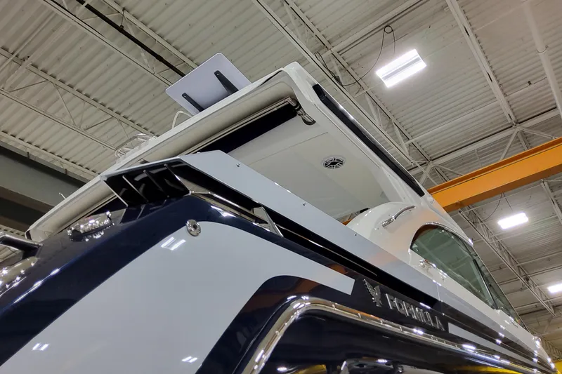 Slide: The Image of 2026 Formula 380 Super Sport Crossover OB boat in a showroom, viewed from below. - 4