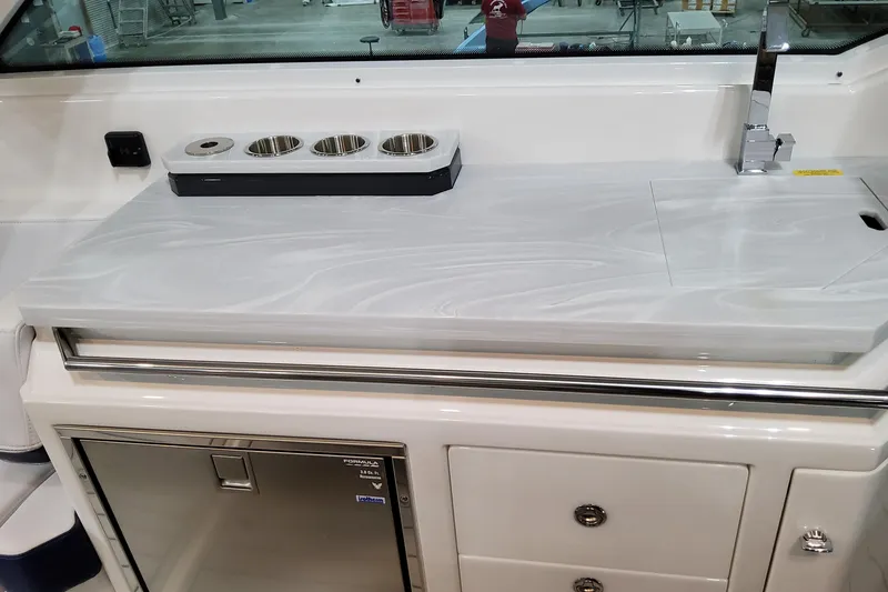 Slide: The Image of 2026 Formula 380 Super Sport Crossover OB boat interior with sleek countertop and storage. - 50
