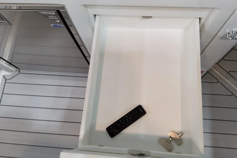 Slide: The Image of Open drawer with remote and keys on Formula 380 Super Sport Crossover OB, 2026 model. - 51