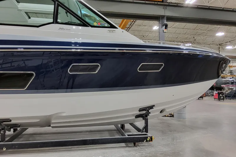 Slide: The Image of 2026 Formula 380 Super Sport Crossover OB boat in a showroom, side view. - 6