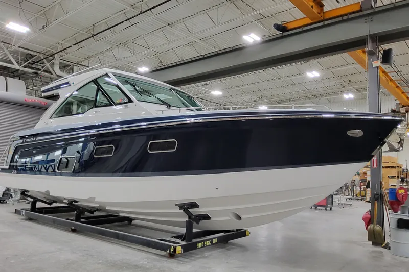 Slide: The Image of 2026 Formula 380 Super Sport Crossover OB boat in a showroom, showcasing sleek design. - 8