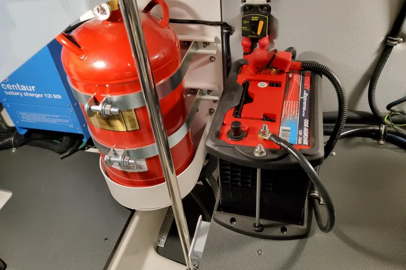 Slide: The Image of Engine room of 2026 Formula 380 Super Sport Crossover OB with battery and fire extinguisher. - 87