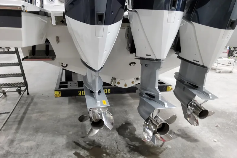 Slide: The Image of 2026 Formula 380 Super Sport Crossover OB with triple outboard engines in a workshop. - 9