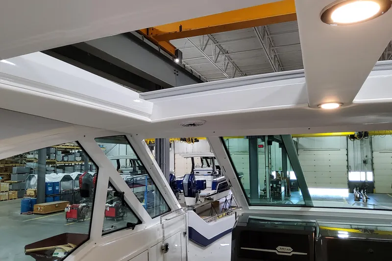 Slide: The Image of Interior view of 2026 Formula 380 Super Sport Crossover OB boat in a workshop. - 95