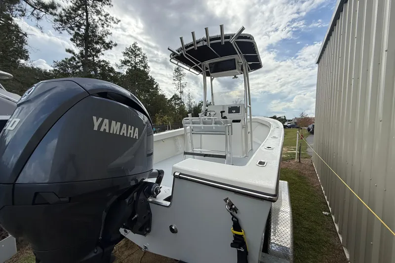 Slide: The Image of 2024 May-Craft 20 Cape Classic boat with Yamaha engine, parked outdoors near a building. - 4