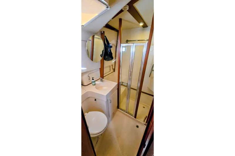 Slide: The Image of Bathroom interior of 2000 Mainship 390 Trawler with shower and vanity. - 12
