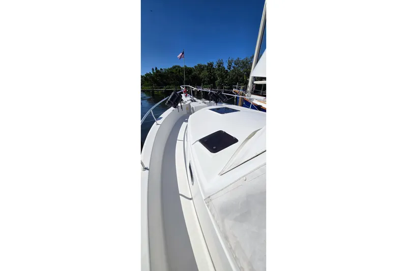 Slide: The Image of 2000 Mainship 390 Trawler deck view with clear sky and water background. - 14