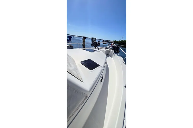 Slide: The Image of 2000 Mainship 390 Trawler on calm water under clear blue sky. - 16