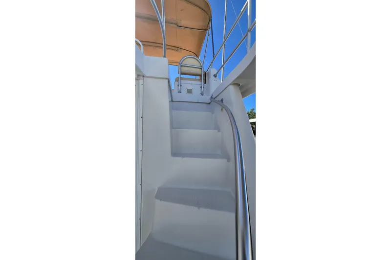 Slide: The Image of Staircase on 2000 Mainship 390 Trawler with metal handrails and canopy. - 19