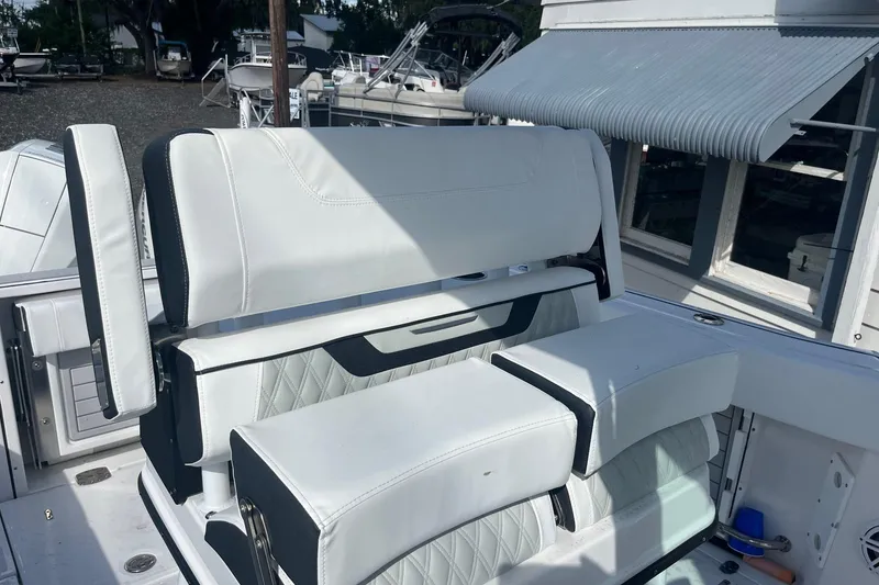 Slide: The Image of 2025 Blackfin 252 CC boat with white cushioned seating and armrests. - 10