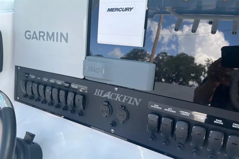 Slide: The Image of 2025 Blackfin 252 CC boat dashboard with Garmin and Mercury controls. - 11