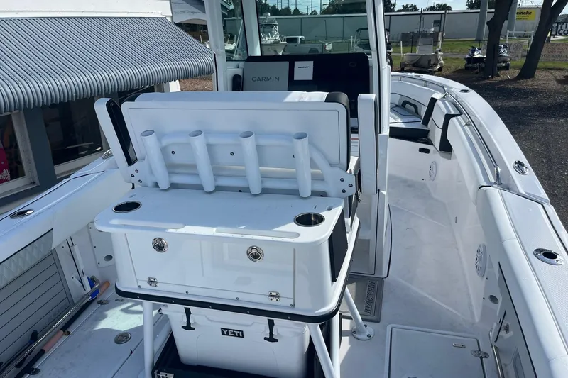 Slide: The Image of 2025 Blackfin 252 CC boat interior with rod holders and Yeti cooler. - 15