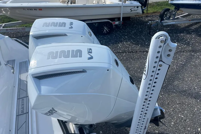 Slide: The Image of 2025 Blackfin 252 CC boat with dual V6 outboard engines, parked on a trailer. - 21
