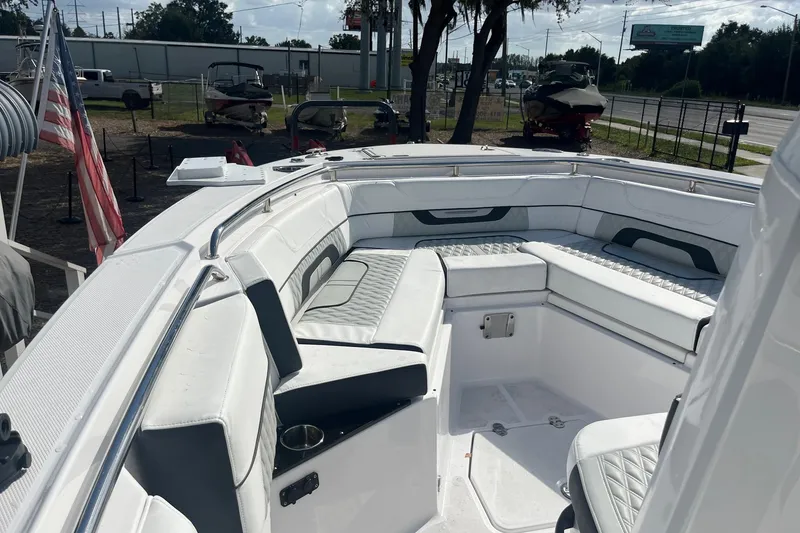 Slide: The Image of 2025 Blackfin 252 CC boat interior with white cushioned seating and cup holders. - 9
