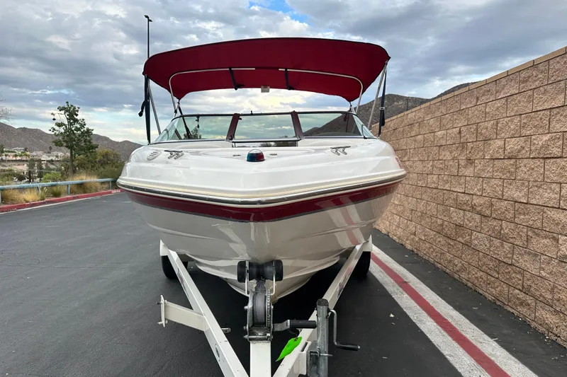 Slide: The Image of 2002 Chaparral 183 SS boat interior with white seating and built-in speakers. - 8