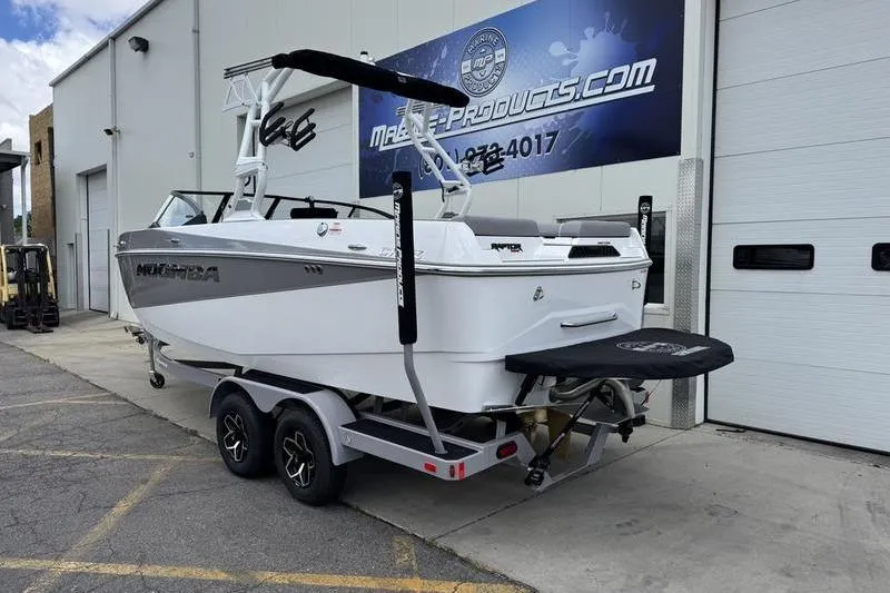 Slide: The Image of 2025 Moomba Craz boat on trailer outside a warehouse. - 3