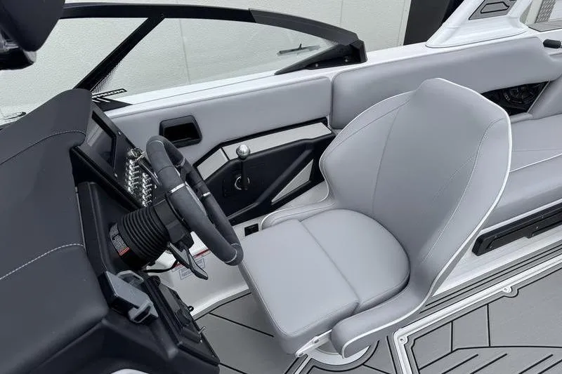 Slide: The Image of 2025 Moomba Craz boat interior with sleek gray seating and modern steering wheel design. - 4