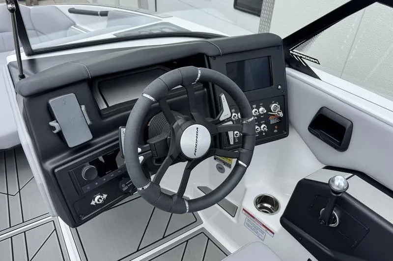 Slide: The Image of 2025 Moomba Craz boat dashboard with steering wheel and control panel. - 8