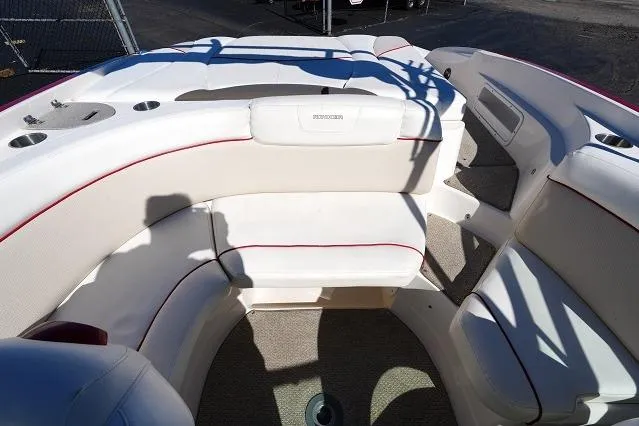 Slide: The Image of 2007 Rinker 226 Captiva Bowrider interior with white seating and red accents. - 12