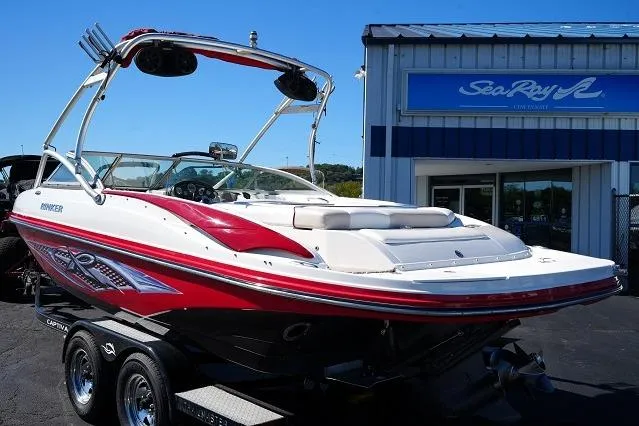Slide: The Image of 2007 Rinker 226 Captiva Bowrider boat on trailer, parked outside dealership. - 5