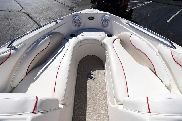 Slide: The Image of 2007 Rinker 226 Captiva Bowrider interior with white seating and red accents. - 6
