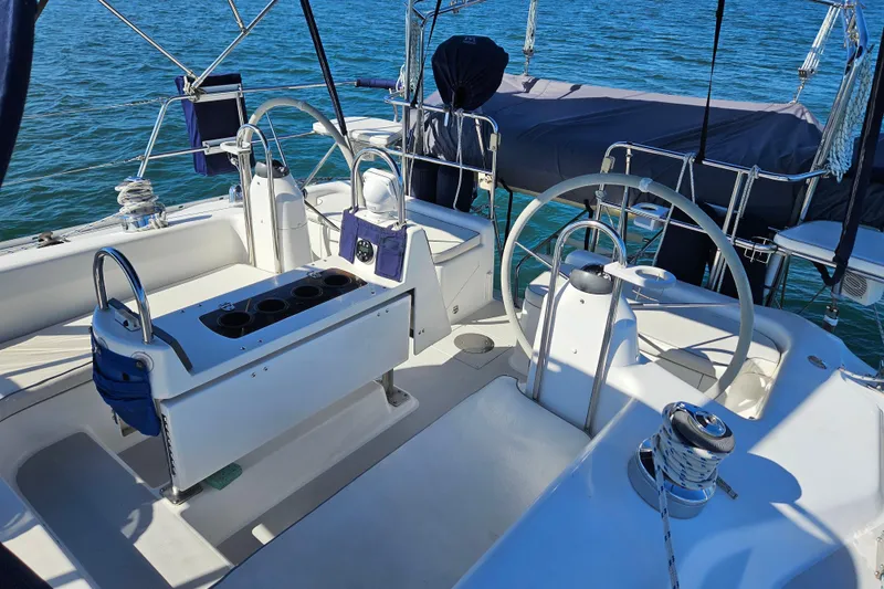 Slide: The Image of 2006 Catalina 400 MkII sailboat cockpit with dual steering wheels and ocean backdrop. - 1