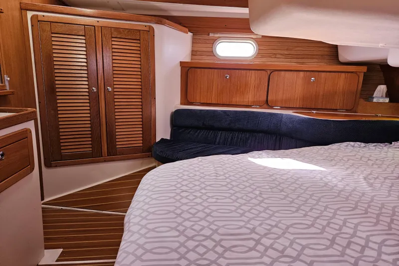 Slide: The Image of Interior of 2006 Catalina 400 MkII sailboat with wood cabinetry and cozy sleeping area. - 12