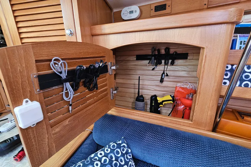 Slide: The Image of Wooden cabinet in a 2006 Catalina 400 MkII yacht, storing tools and cables. - 15