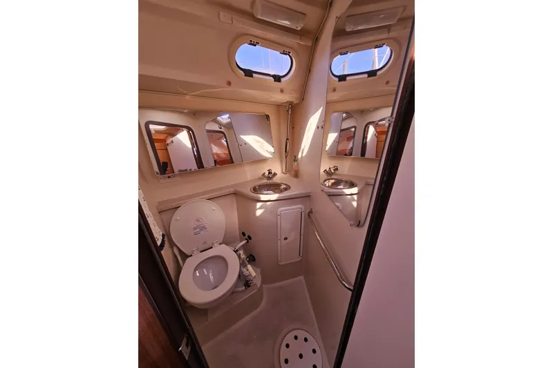 Slide: The Image of Interior of 2006 Catalina 400 MkII yacht bathroom with toilet and sink. - 16