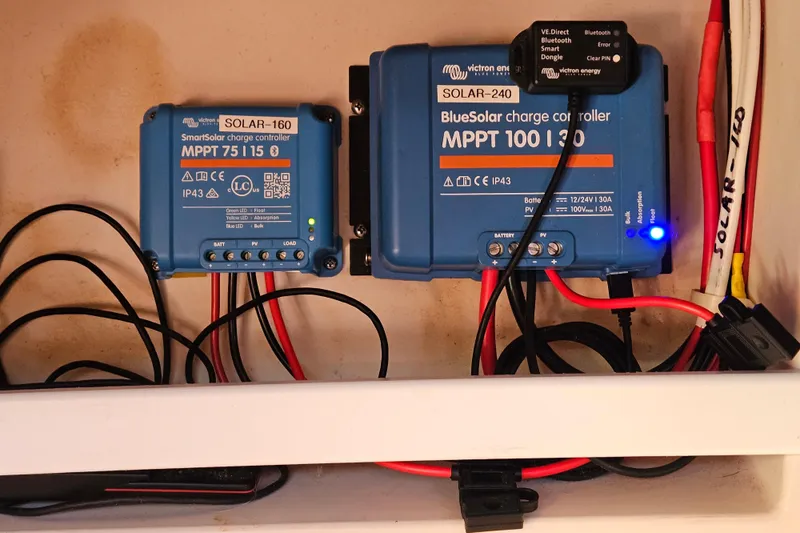 Slide: The Image of Victron Energy charge controllers in Catalina 400 MkII, 2006 model, with wiring connections. - 18