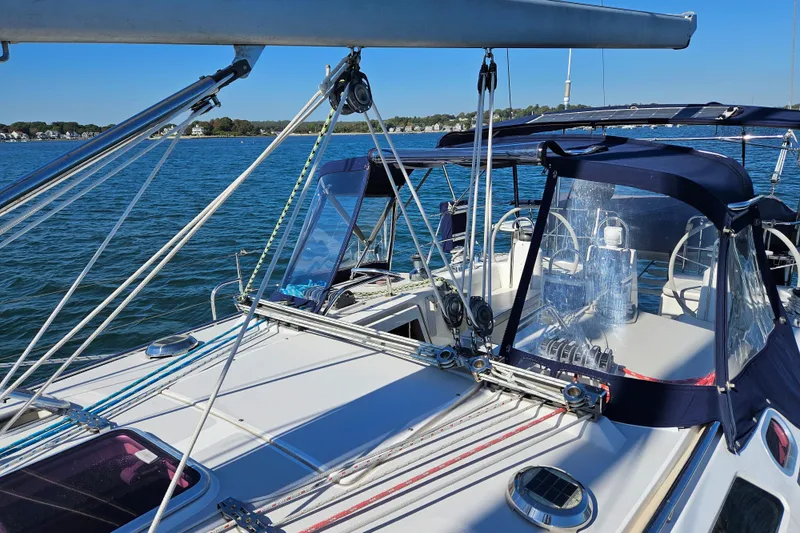 Slide: The Image of 2006 Catalina 400 MkII sailboat deck with blue canopy on calm water. - 2