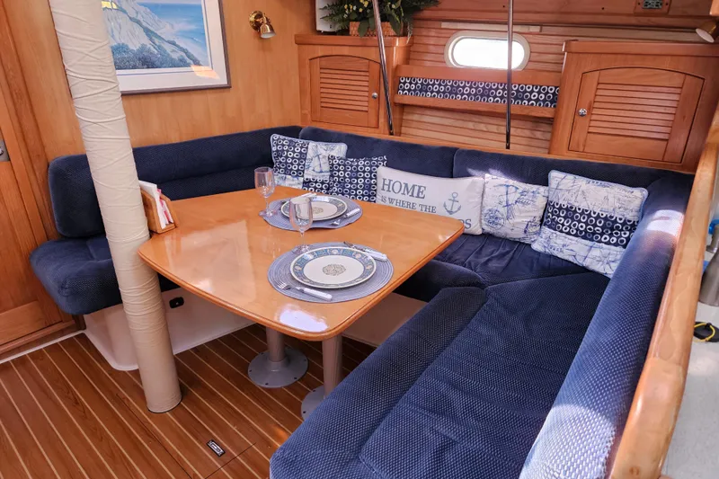 Slide: The Image of Cozy interior of 2006 Catalina 400 MkII sailboat with dining area and nautical decor. - 6