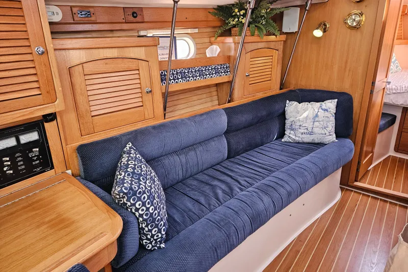 Slide: The Image of Interior of 2006 Catalina 400 MkII sailboat with blue cushioned seating and wooden cabinetry. - 7