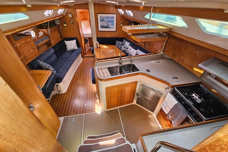 Slide: The Image of Interior of 2006 Catalina 400 MkII yacht with kitchen and seating area. - 8