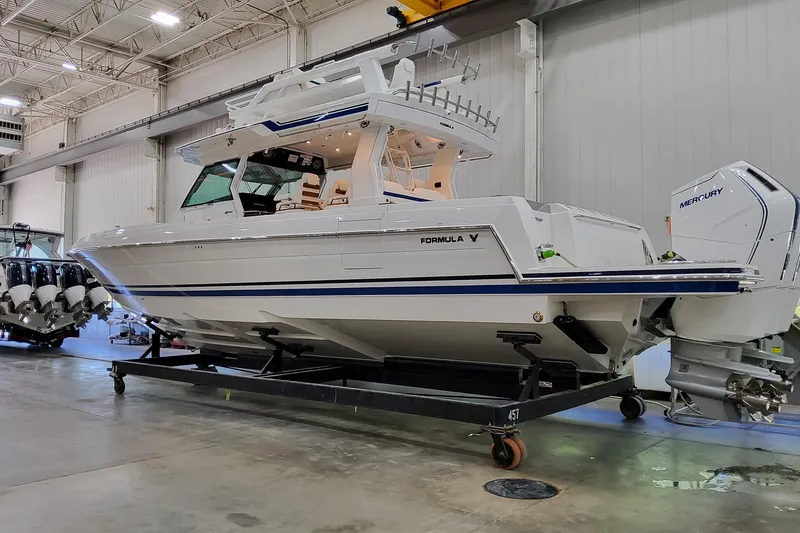 Slide: The Image of 2026 Formula 457 Center Console Fish boat in a showroom, featuring Mercury engines. - 1