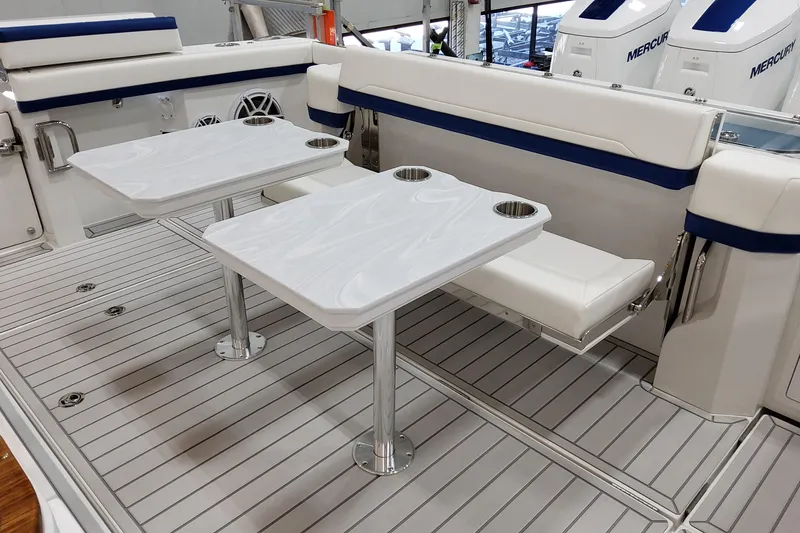 Slide: The Image of 2026 Formula 457 Center Console Fish boat interior with seating and dual tables. - 16